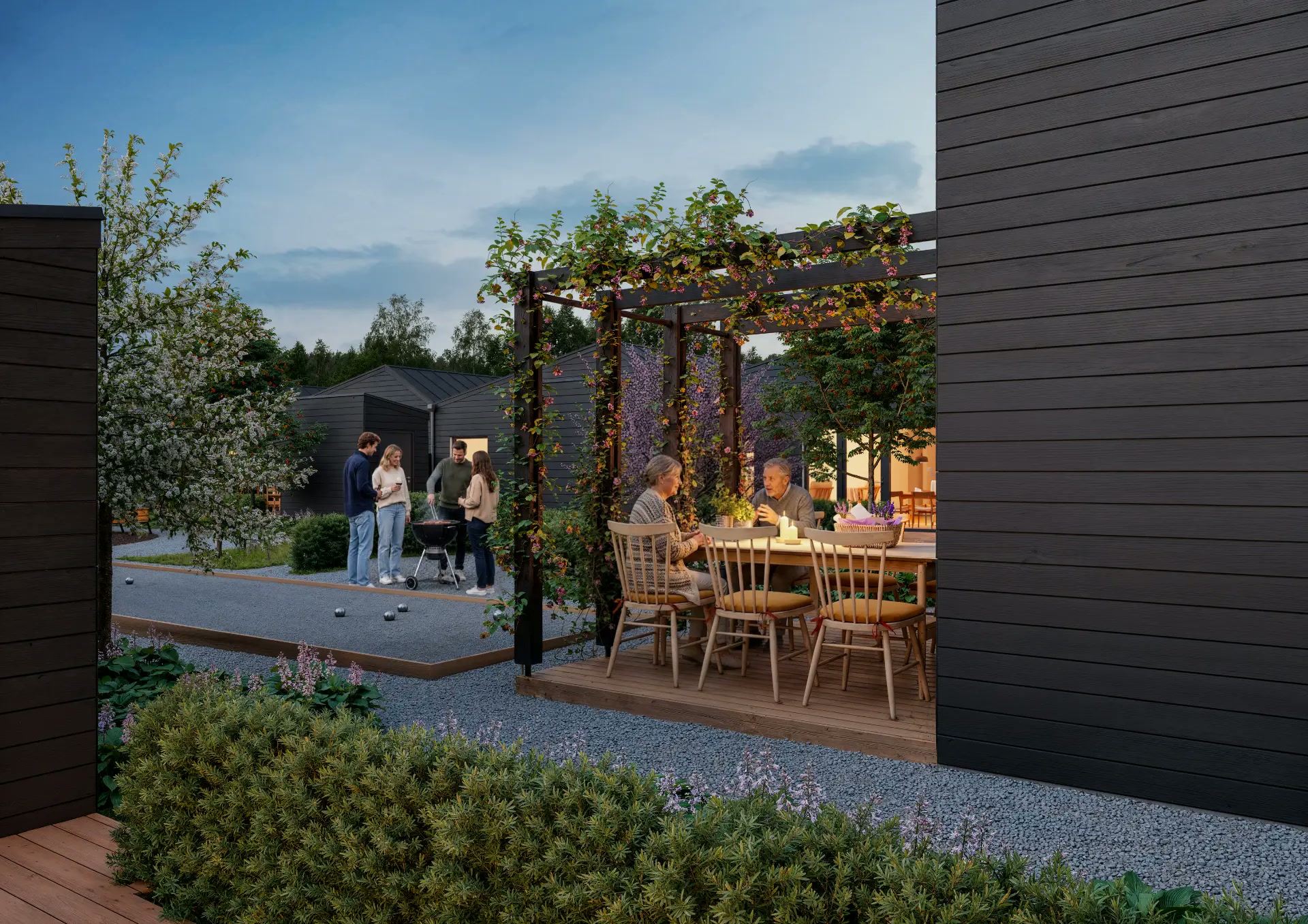 Pergola med matbord och kvällsbelysning på innergården